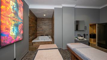 A modern bathroom with a wooden wall, a large mirror, a sink, and a bathtub.