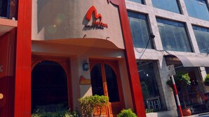 A modern building with a prominent logo and multiple windows. - hotel manduara (Asunción)
