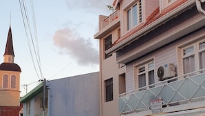 A street view with a building featuring a boutique store named "St. Anne" with mannequins displaying clothing.