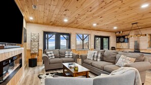 A cozy living room with wooden ceilings, a fireplace, and a billiards setup. - Private Mountain Cabin Retreat 1.5 acres, Amazing Views, Hot Tub, STARLINK Wifi (Murphy)