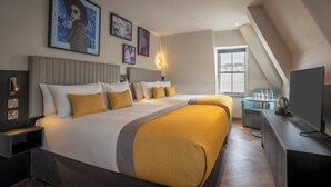 A hotel room with two beds, a TV, and artwork on the walls. - Maldron Hotel Brighton City Centre (Brighton)