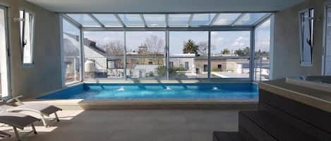 Indoor pool, open 9:00 AM to 10:00 PM, pool loungers