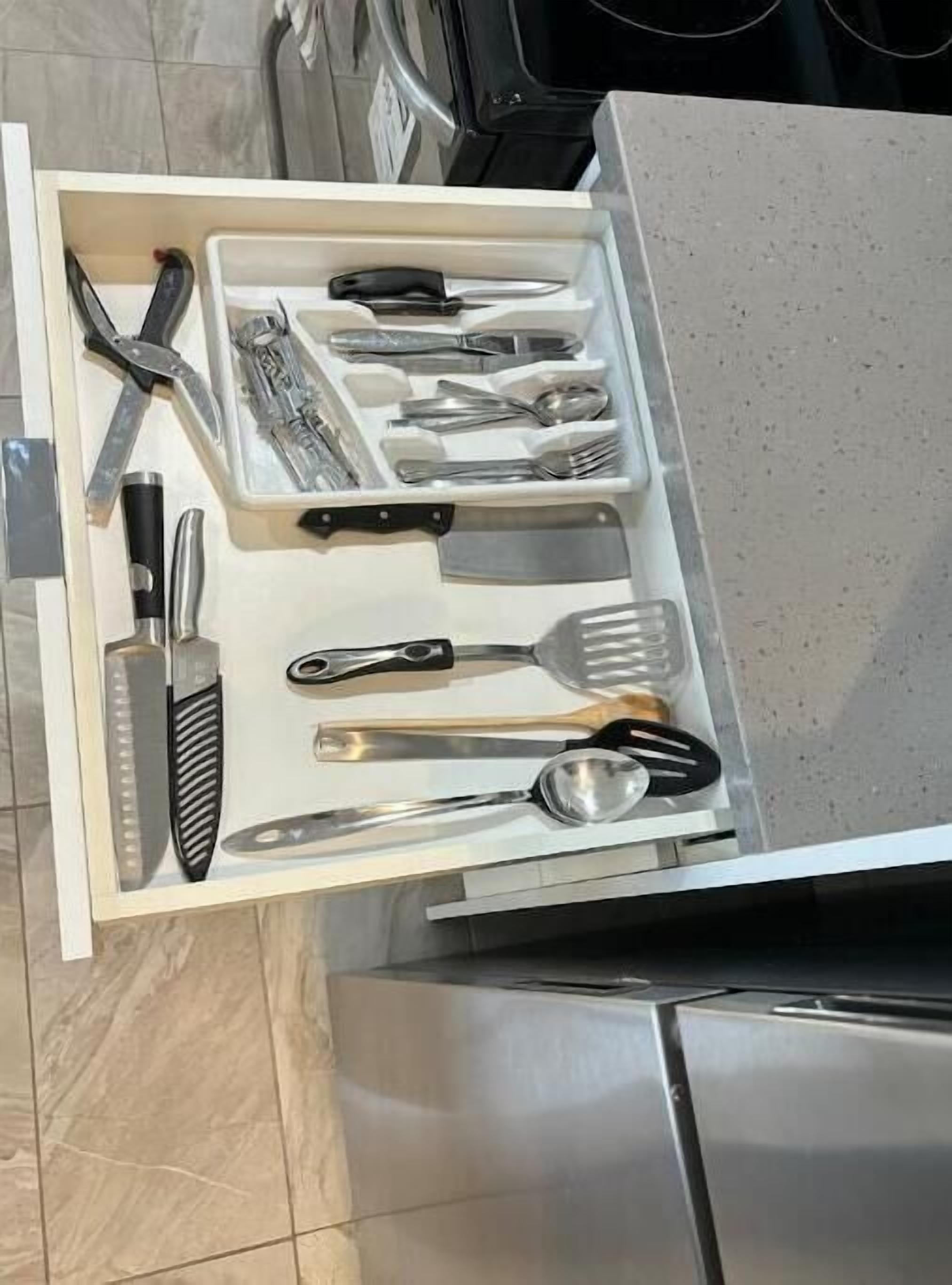 A kitchen drawer with utensils neatly organized.