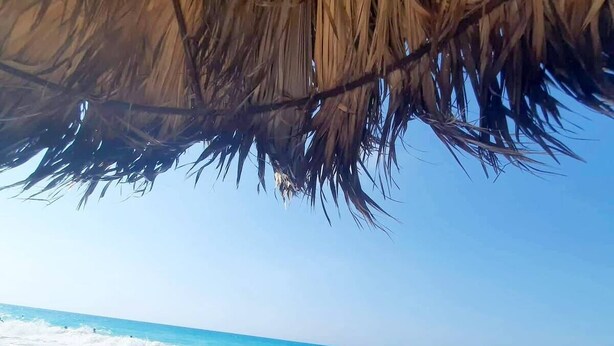 A beach with clear turquoise water and white sand.