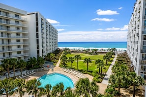 A resort with a swimming pool, palm trees, and a view of the ocean. - Mainsail 433 - Gulf-Front, Wonderful Onsite Amenities, Free Beach Service! (Miramar Beach)