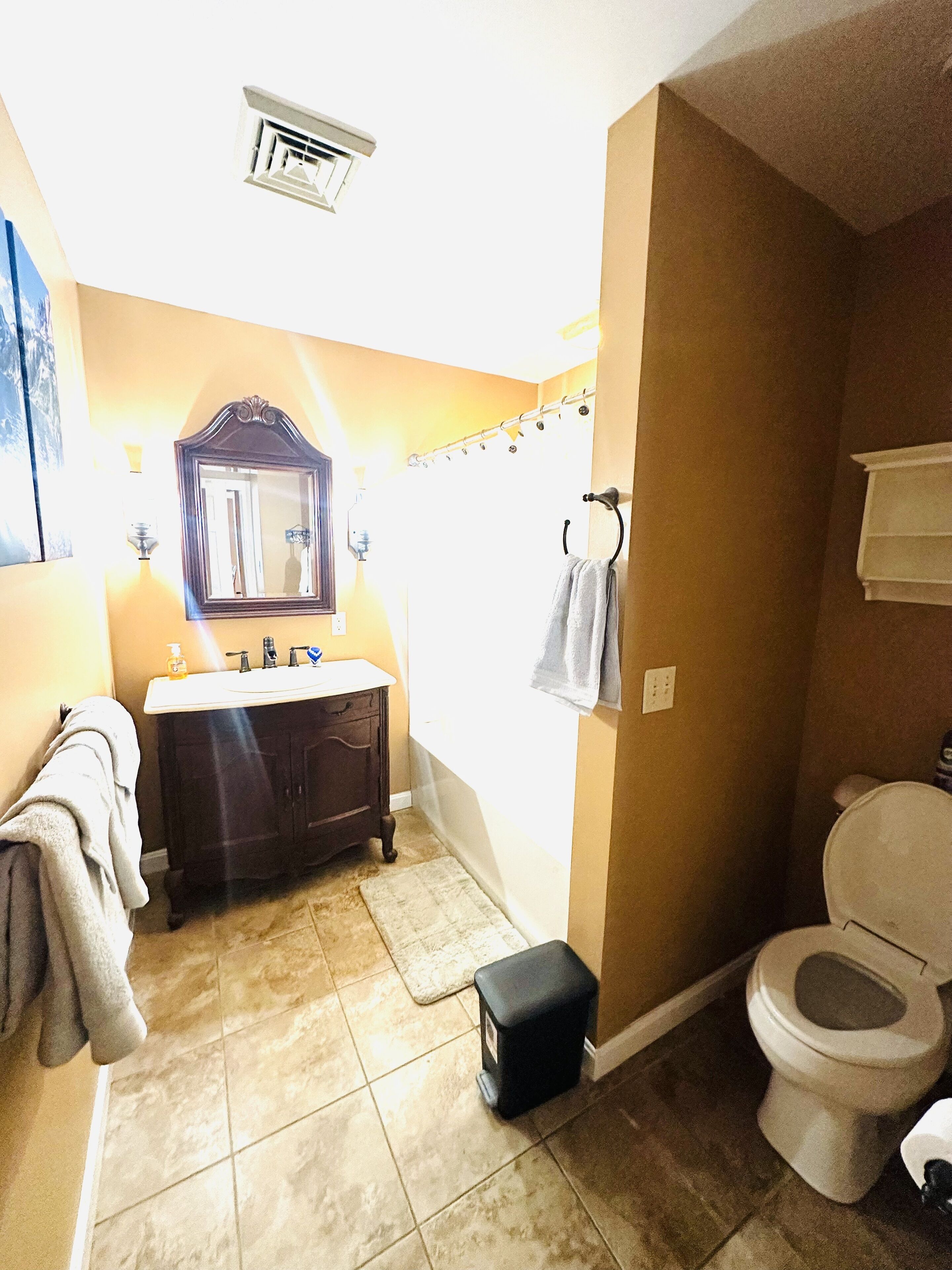A bathroom with a sink, mirror, and toilet.