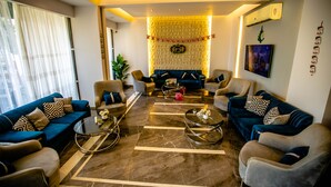 A modern living room with a sofa set, armchairs, and a coffee table. - Pyramids Chill Out (Giza)