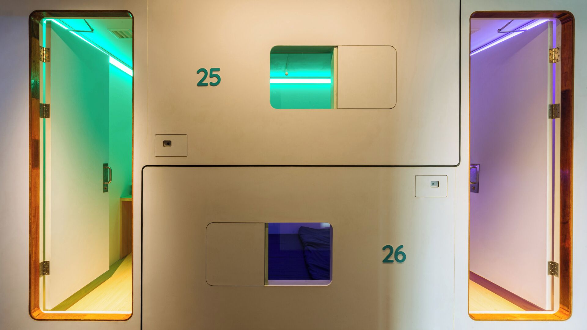 A hotel room with two doors, each marked with a number (25 and 26).