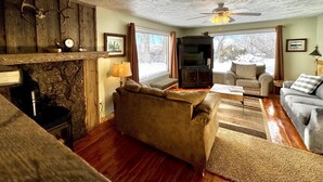 A cozy living room with a fireplace, a television, and a comfortable seating area. - Edge Water Lodge (EV), Waters Edge Lodge (Fremont County)