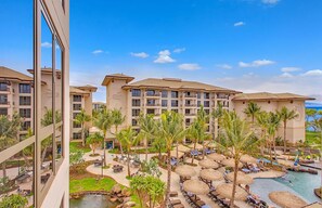 A resort with multiple buildings, outdoor pools, and palm trees.