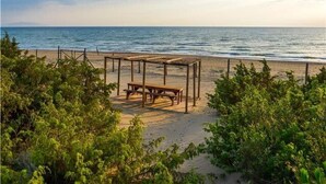A beach with a wooden gazebo and a bench. - In the Maremma Classic Tuscany Villa With Pool Near the Sea (Castagneto Carducci)