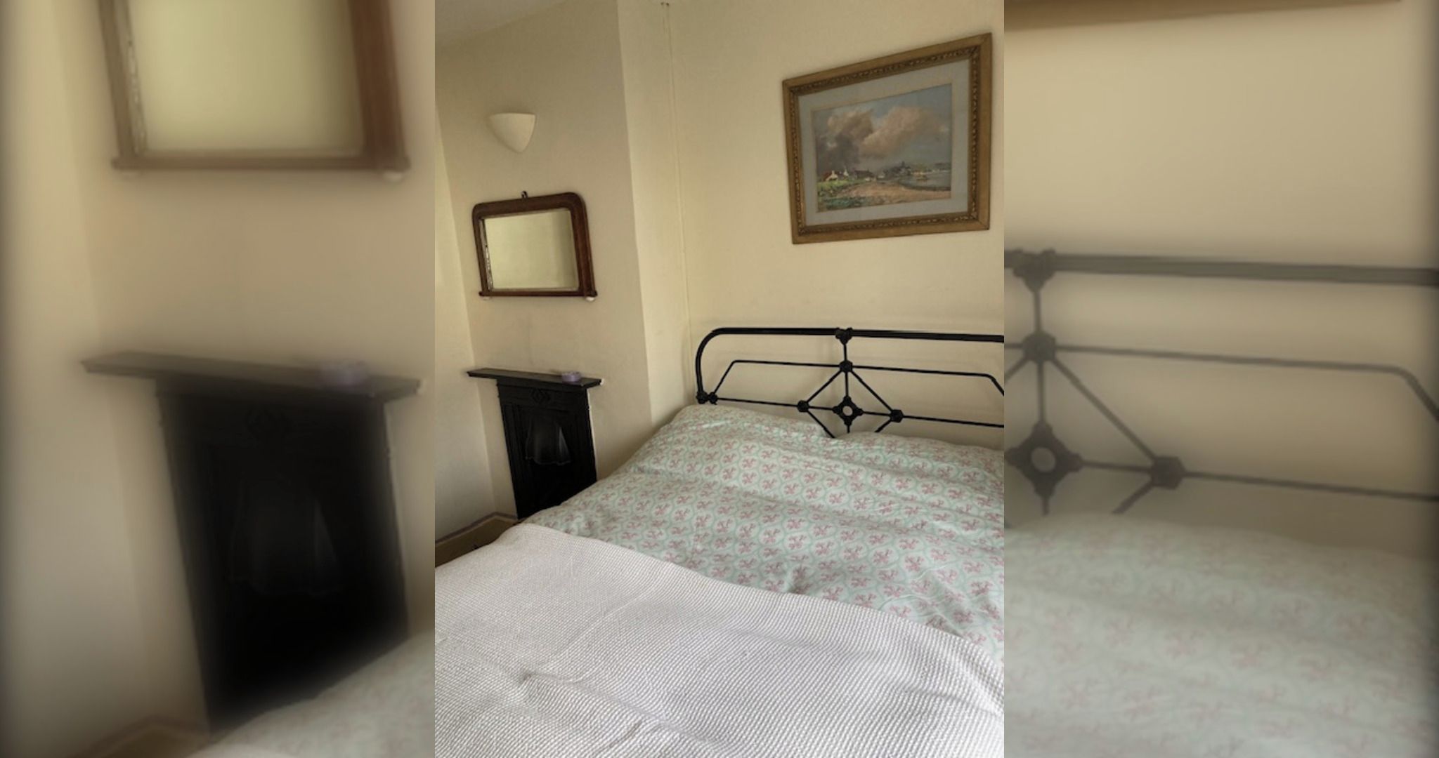 A bedroom with a bed, a dresser, a mirror, and a painting on the wall.