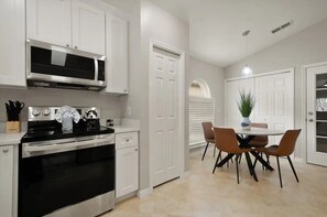 Enjoy meals in the kitchen with a microwave and oven, and dine at the round table with four chairs.