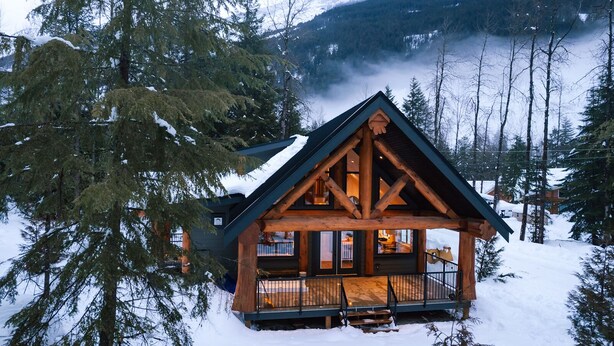 A log cabin with a balcony, surrounded by snow-covered trees and mountains. - Escape to a cabin in the woods (Sunshine Valley, BC, Canada) (Sunshine Valley)