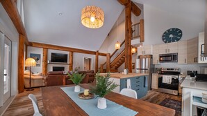 A spacious kitchen with modern appliances, a dining area with a wooden table, and a cozy living room with a fireplace. - Escape to a cabin in the woods (Sunshine Valley, BC, Canada) (Sunshine Valley)