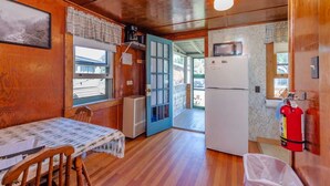 A compact kitchen with a refrigerator, a microwave, and a fire extinguisher. - Gorgeous Escape, Steps Away from Fourth Lake at Stiefvater's Lakeside Cottages (Inlet)