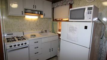 Fridge, microwave, coffee/tea maker, cookware/dishes/utensils