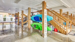 A covered outdoor area with a wooden staircase, kayaks, and a sign that reads "HELLO". - Townhome w/ Outdoor Pool & White Lake Access! (Elizabethtown)