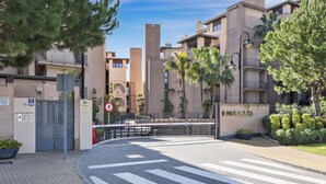 A gated entrance to a residential building with a pedestrian crossing and a sign indicating no pedestrian access. - Penthouse Bahia de la Plata (Estepona)