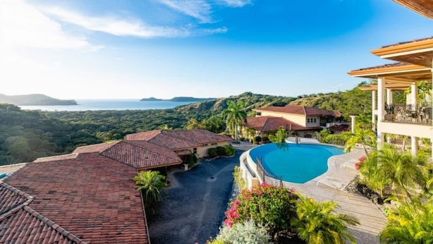 A resort with a swimming pool, multiple buildings, and a view of the ocean. - Bay Point 7 • 3 BR Ocean-View Condo • Two Infinity Pools, Playa Panamá - 6 Guests (Playa Hermosa)