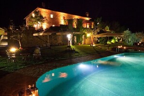 Enjoy a refreshing swim in the pool surrounded by a beautifully landscaped outdoor space.