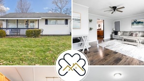 A house with a front yard, a living room with a sofa and a ceiling fan, a kitchen with wooden cabinets and a dining area with a table and chairs.