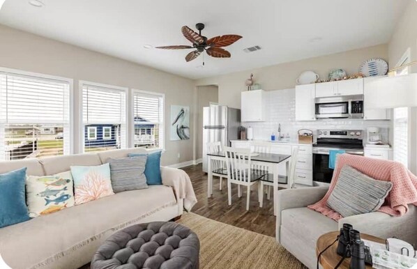 A modern kitchen with white cabinets, a microwave, and a coffee maker.