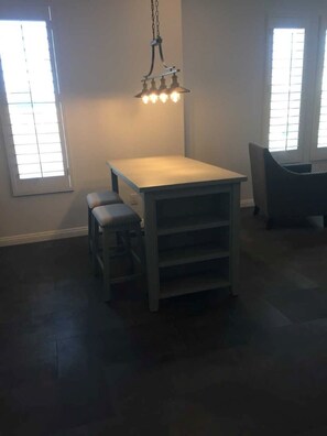 Enjoy casual dining or meetings in this functional room with a central table and pendant light.