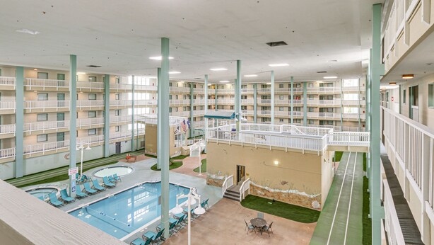 A multi-level indoor pool area with multiple balconies and lounge chairs. - Walk to Beach: Hilton Head Resort Condo w/ Pools! (Hilton Head Island)