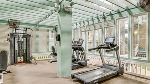 A gym with treadmills, a weight machine, and a fan. - Walk to Beach: Hilton Head Resort Condo w/ Pools! (Hilton Head Island)