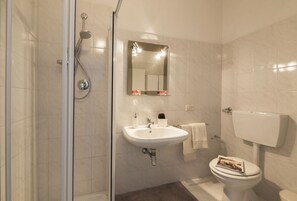 Een douche, een haardroger, een bidet, handdoeken