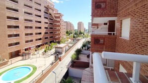 A multi-story building with a courtyard, a swimming pool, and a staircase. - ACV - Playa Coral I-2ª Linea Planta 3 Norte (OROPESA)