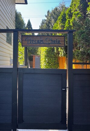 A wooden gate with a sign that reads 'Dream Shala.' - Dream Shala - Eclectic in Nature (North Vancouver)