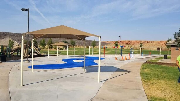 A playground with a slide, a blue circular play area, and a covered seating area. - A Dunes Oasis | Private Pool | Near Sand Hollow (Hurricane)