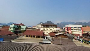 A town with buildings and mountains in the background.