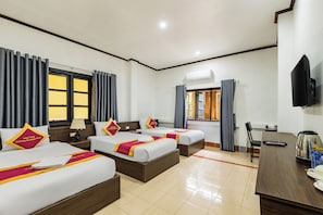 A hotel room with three beds, a TV, a coffee maker, and an air conditioning unit. - Vang Vieng Charming Boutique Hotel (Vang Vieng)