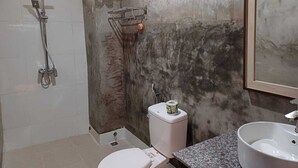 A bathroom with a shower, toilet, and sink.
