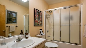 A bathroom with a sink, toilet, and shower. - Memory Mtn Lodge by Velo (Angel Fire)