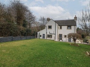 A two-story house with a stone facade, a sloped roof, and a fenced backyard. - Eboracum (Hope Valley)