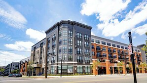 A multi-story hotel with a modern architectural design, featuring large windows and a corner entrance. - Relax & Unwind—Stylish Stay in Cincy’s Heart (Cincinnati)