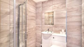 Shower, hair dryer, towels, shampoo