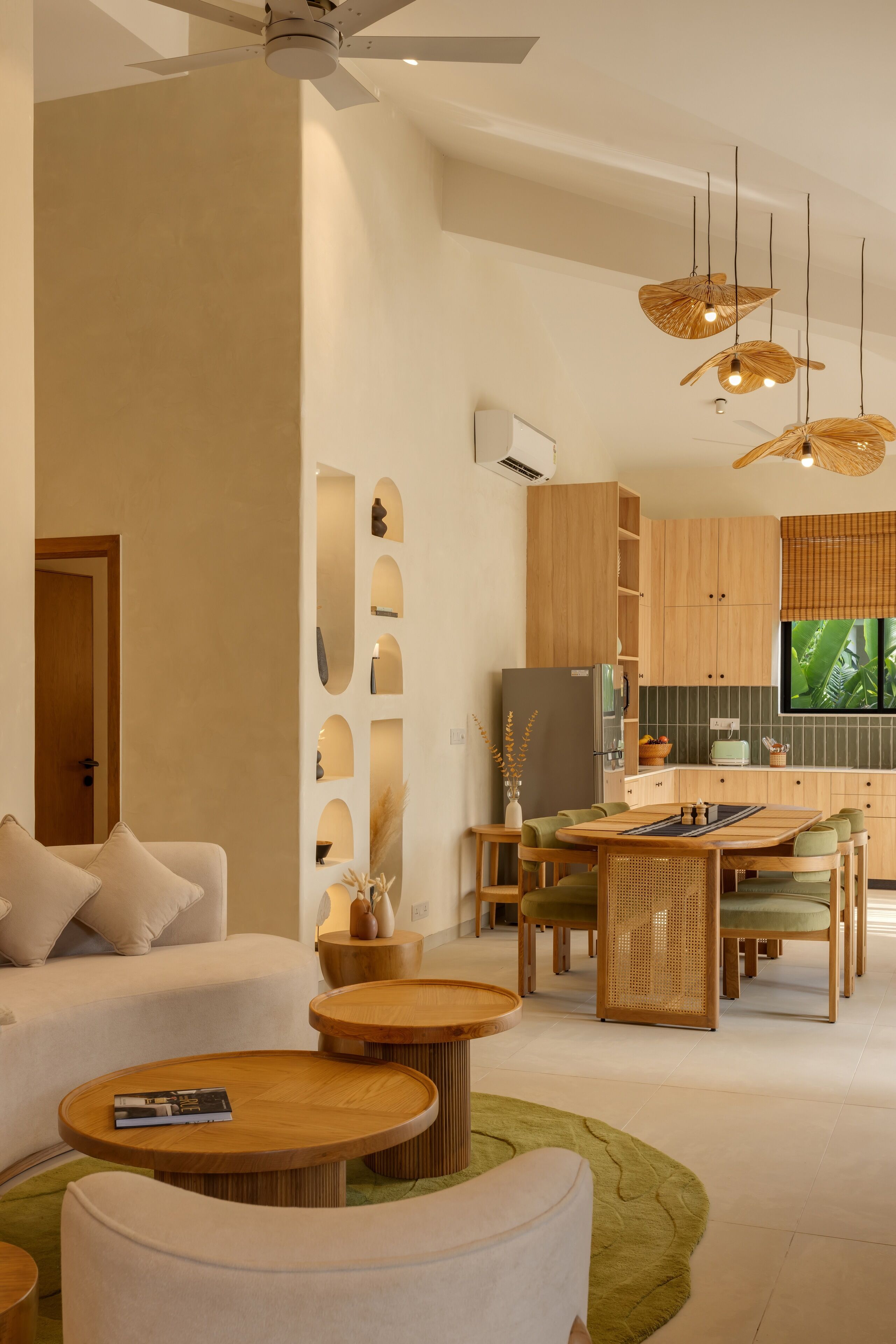 A modern living room with a sofa, coffee table, and dining area.