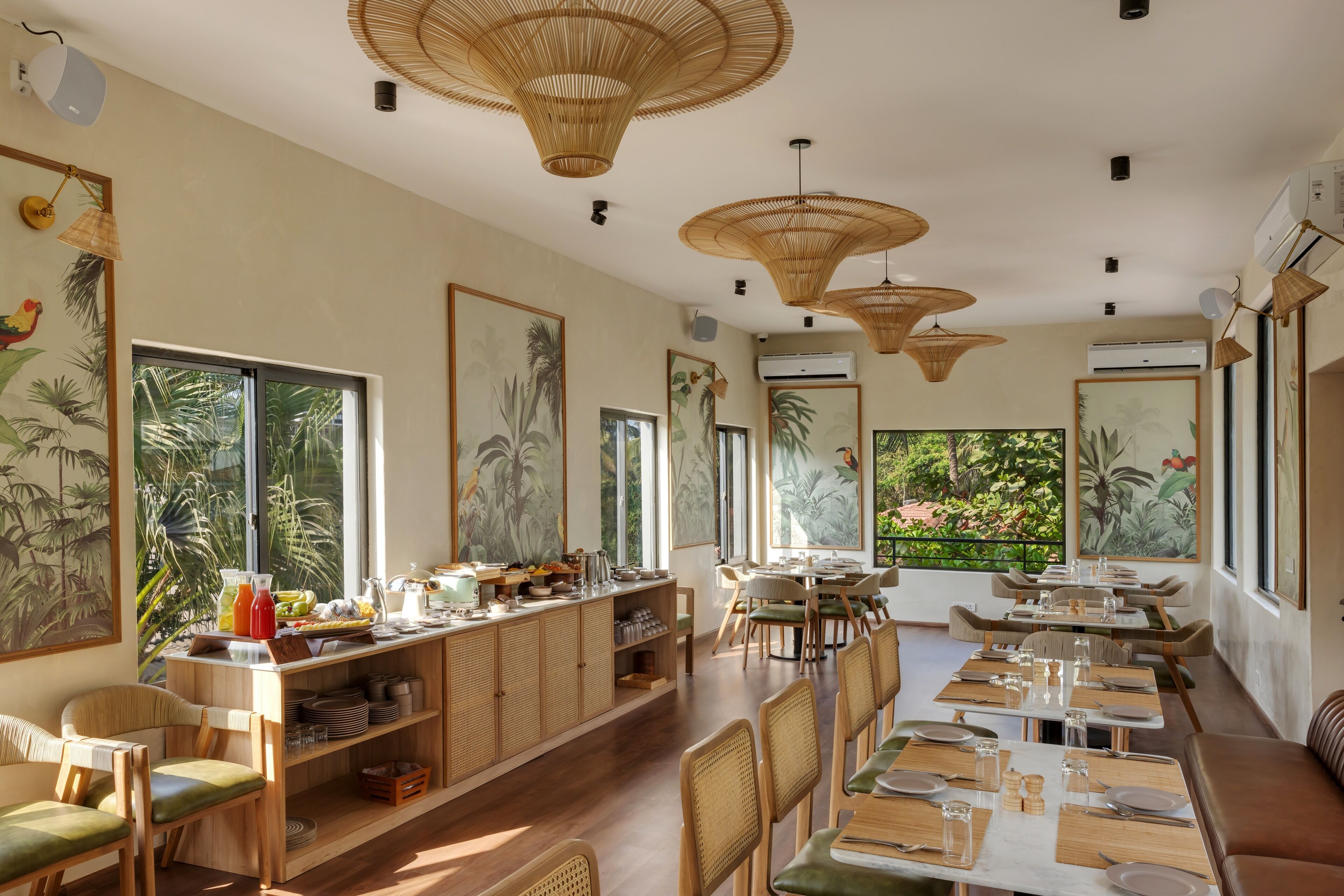 A restaurant with wooden furniture, large windows, and tropical artwork.