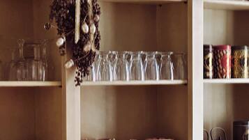 Shelves with glassware, plates, and teapots.