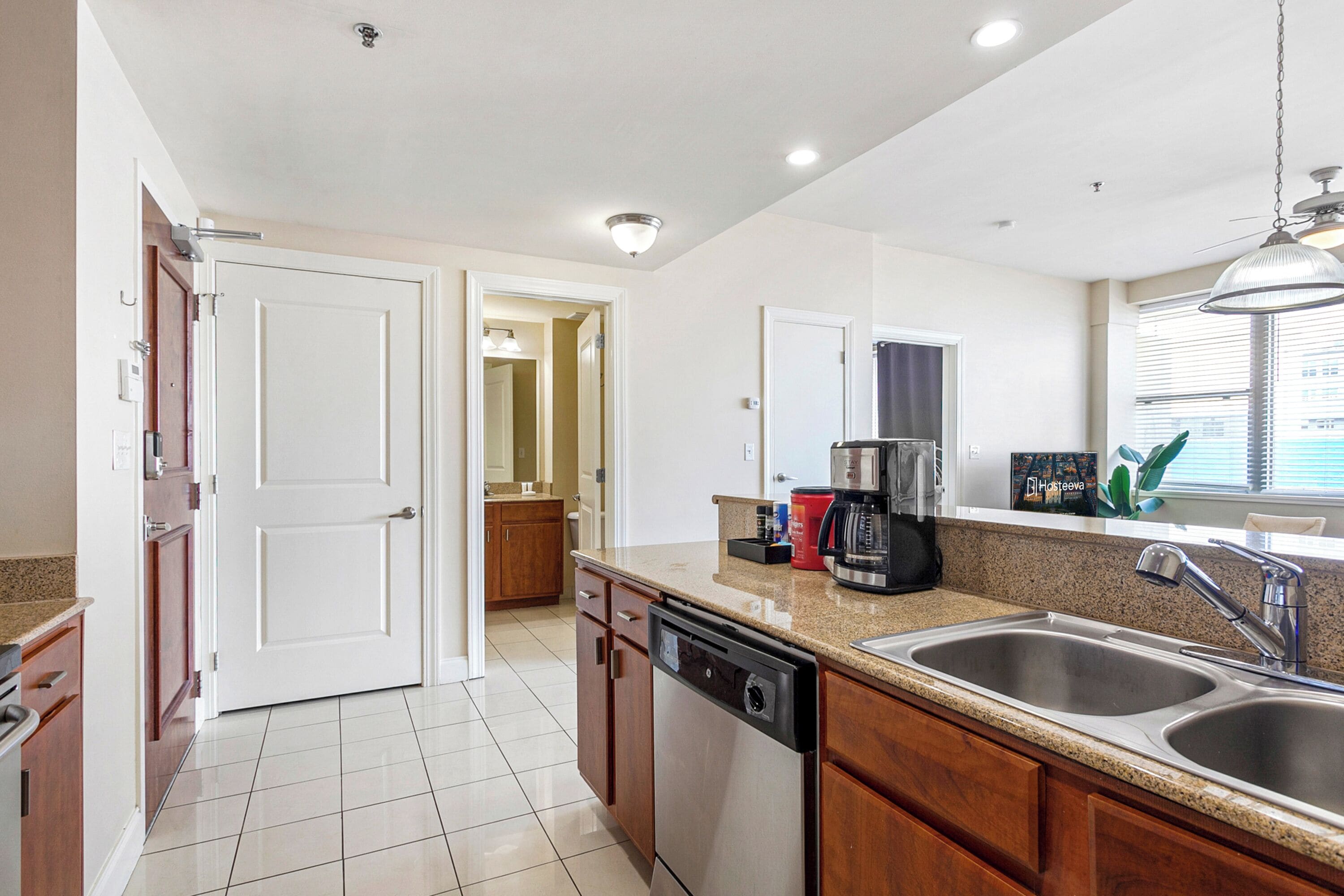 A modern kitchen with stainless steel appliances, a granite countertop, and a double sink.