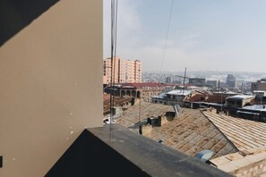 A view from a window overlooking a cityscape with multiple buildings and rooftops. - Modern-style APT/City Centre/Saryan Str (Yerevan)