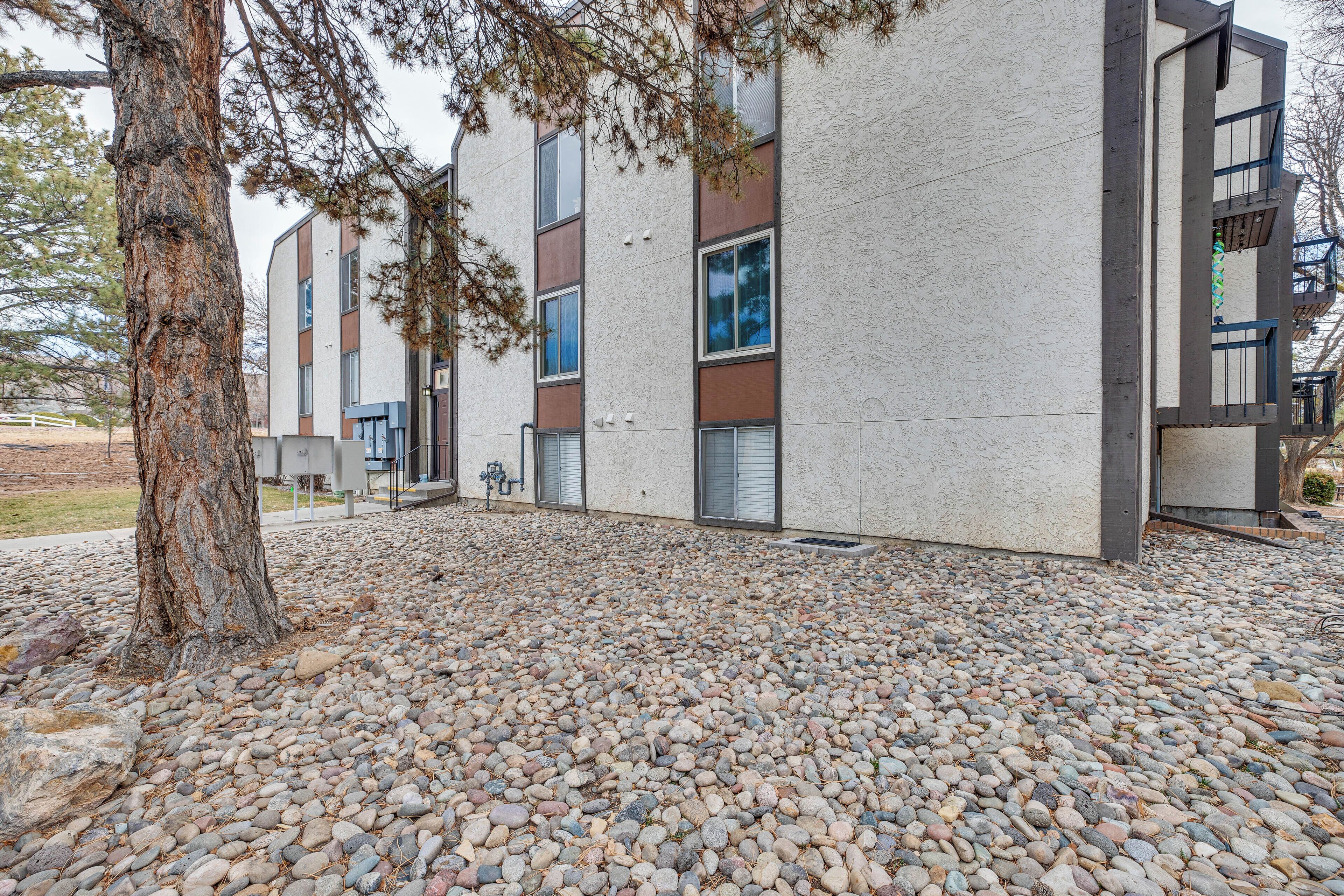 A modern building with a stone facade and multiple windows.