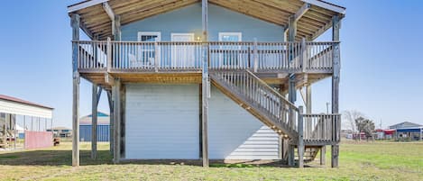A two-story wooden building with a balcony and a staircase.