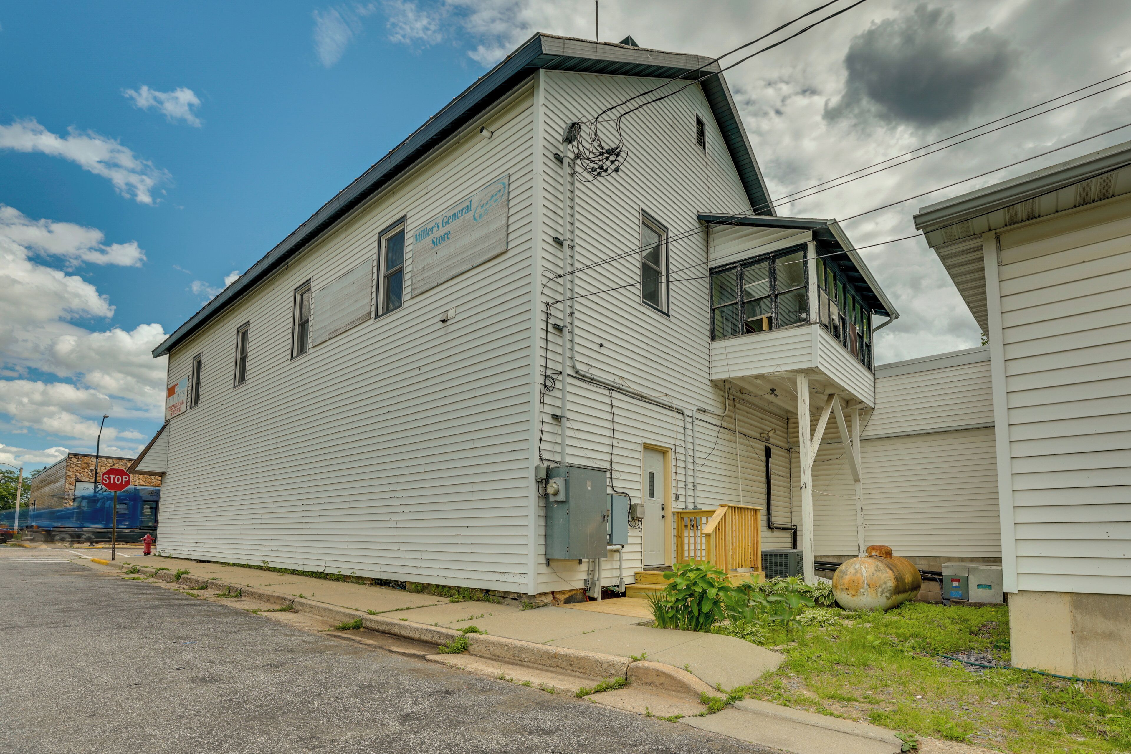 A two-story building with a sign that reads "Miller's General Store."