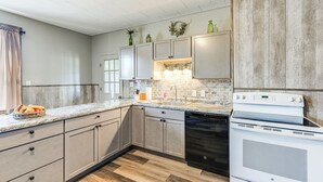 A modern kitchen with light grey cabinets, a white stove, and a dishwasher. - Lyndon Station Retreat ~ 9 Mi to Wisconsin Dells! (Lyndon Station)